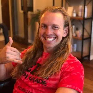 Viktron Rusenas before hair donation, smiling