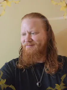 Photo of Man with long red hair. This is a hair donation for Wigs For Kids.